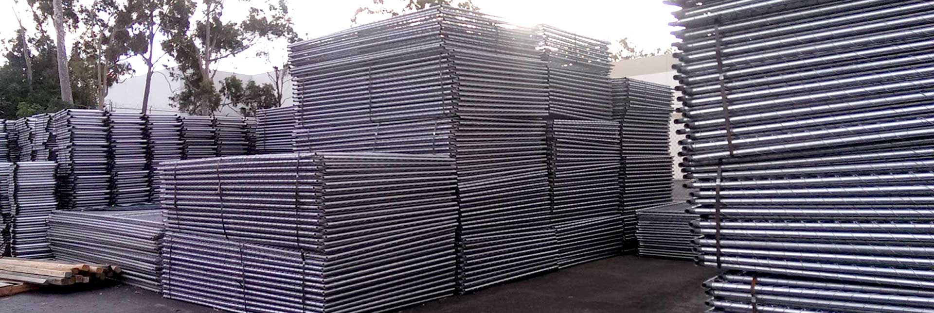 Temporary Fence Panels are stacked in semi-high piles and delievered to an event or construction site by a large truck. Temporary Fence Panels are stacked in semi-high piles and delievered to an event or construction site by a large truck.